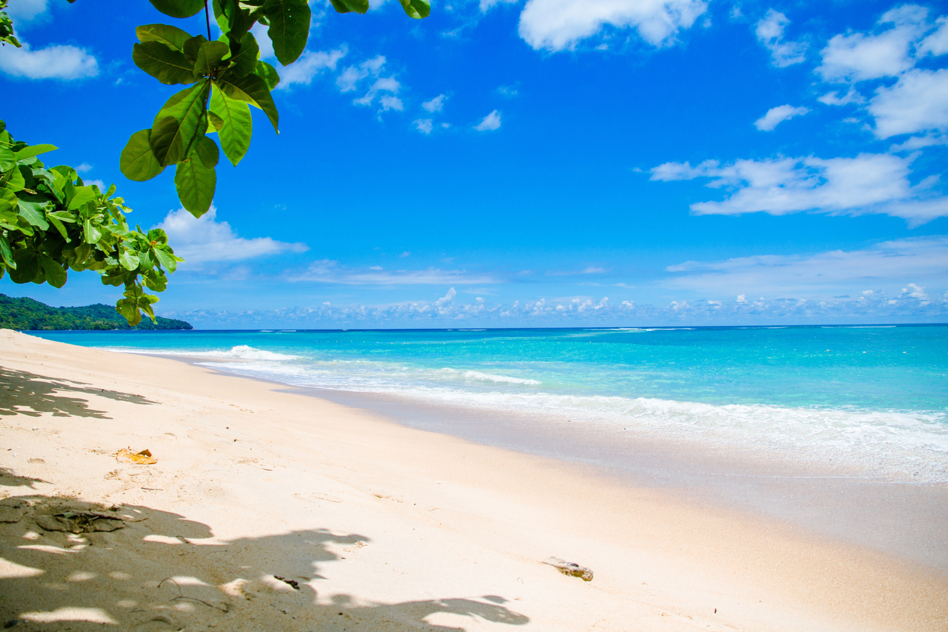 Beautiful beach setting with sand ocean and sky